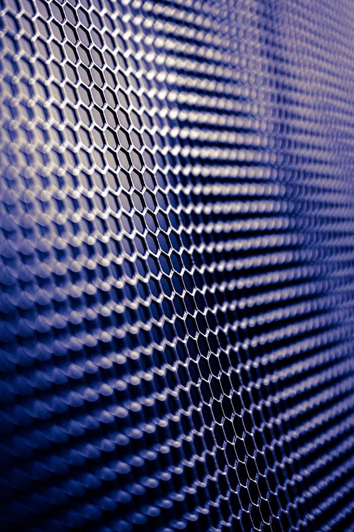 The Art of Drawing Readers In: Your attractive post title goes here Close-up of a futuristic metallic hexagonal pattern, perfect for tech designs.